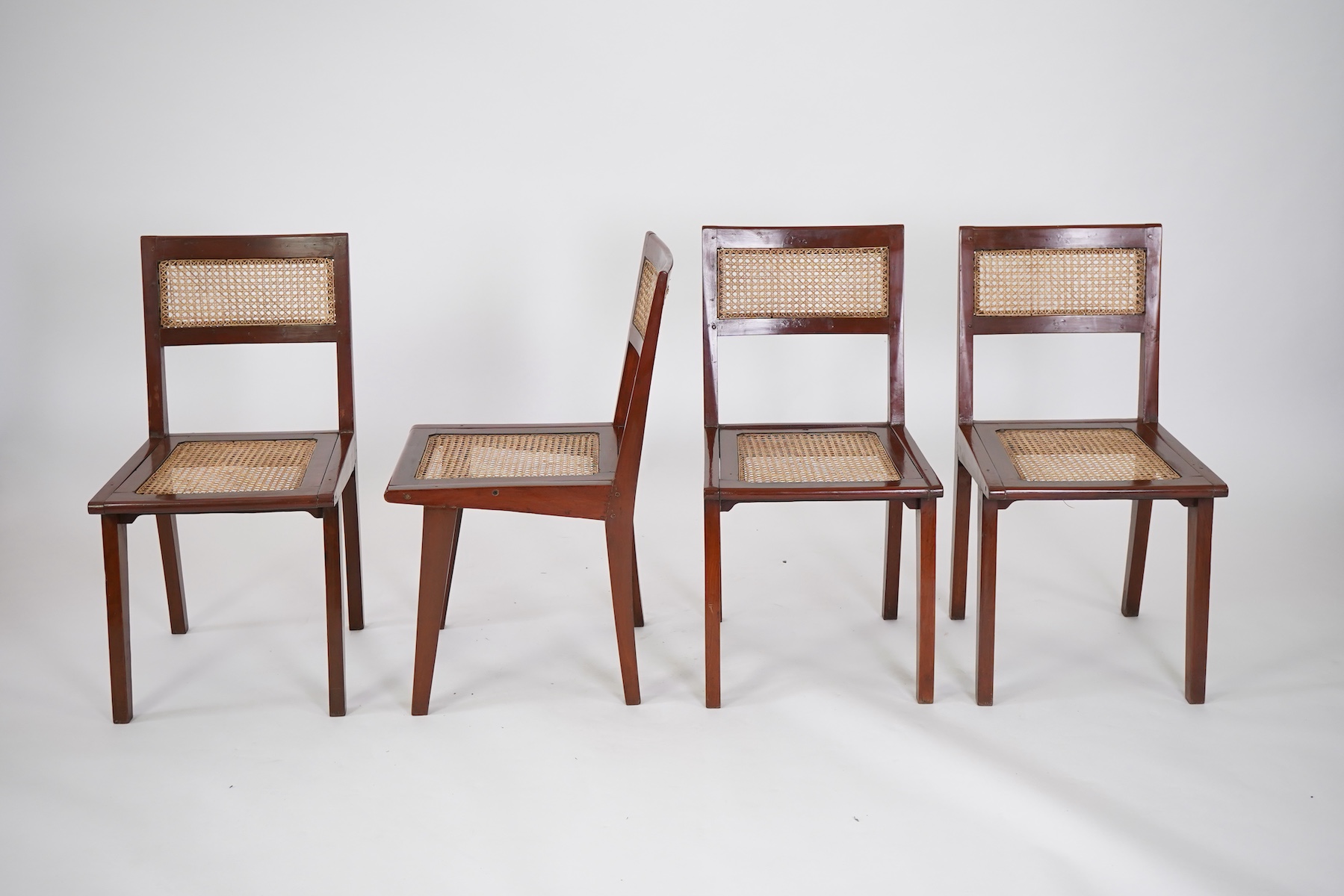 Pierre Jeanneret (Swiss, 1896-1967) for Chandigarh: A set of four solid solid teak and braided canework chairs PJ-010501